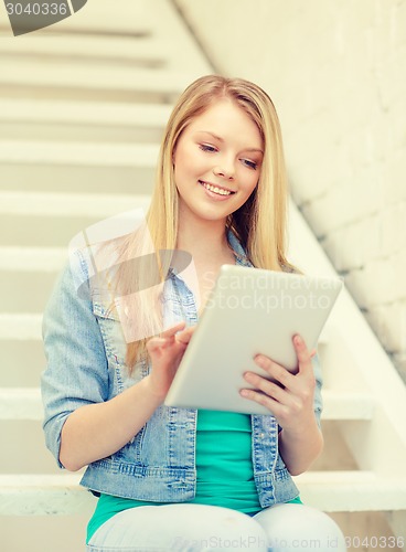 Image of smiling female student with tablet pc computer