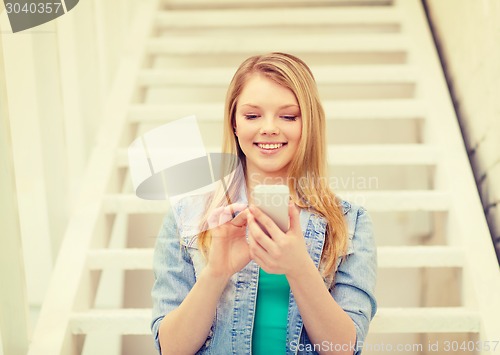 Image of smiling female student with smartphone