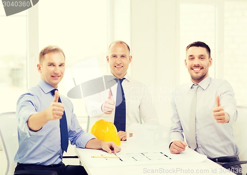 Image of happy team of architects and designers in office