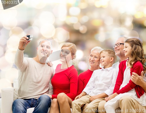 Image of smiling family with camera