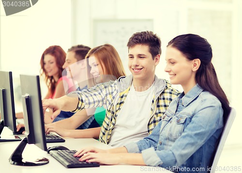 Image of female student with classmates in computer class