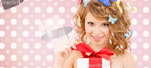 Image of smiling young woman with gift box