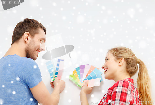 Image of smiling couple selecting color from samples