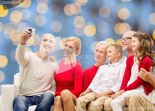 Image of smiling family with camera