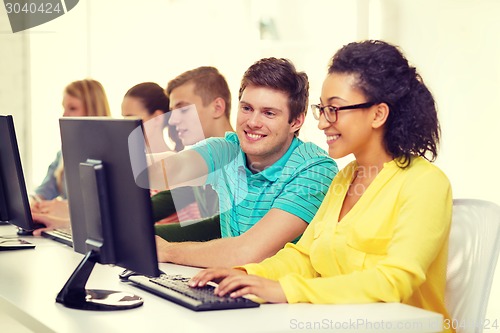 Image of smiling students in computer class at school