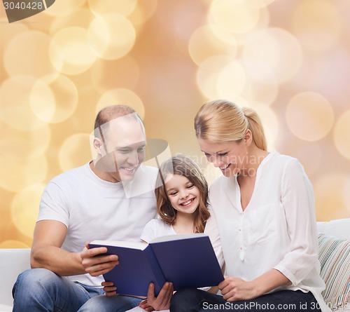 Image of happy family with book at home