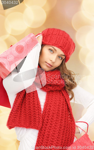 Image of smiling young woman with shopping bags