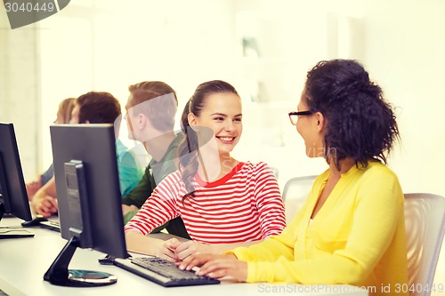 Image of smiling students in computer class at school