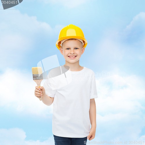 Image of smiling little boy in helmet with paint brush