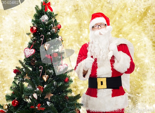 Image of santa claus with bag and christmas tree