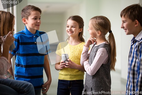 Image of group of school kids with soda cans in corridor