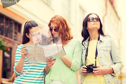 Image of teenage girls with map and camera