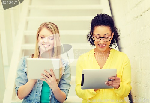 Image of smiling female students with tablet pc computer