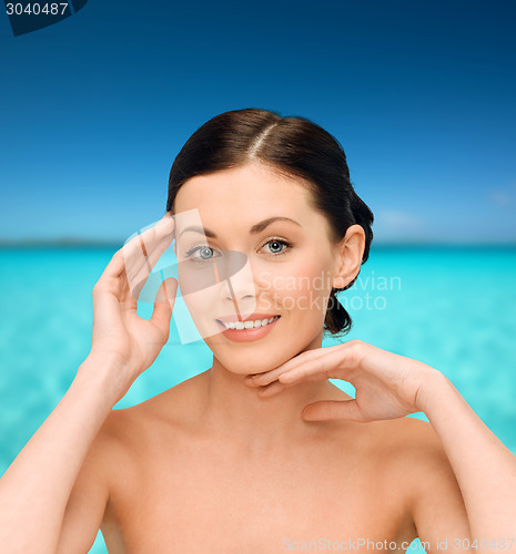 Image of smiling young woman with bare shoulders