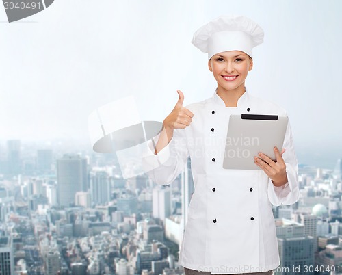 Image of smiling chef with tablet pc showing thumbs up