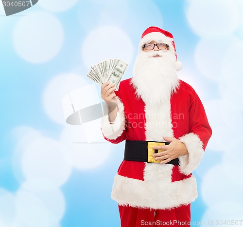 Image of man in costume of santa claus with dollar money