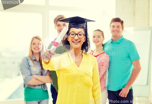 Image of smiling female student with diploma and corner-cap