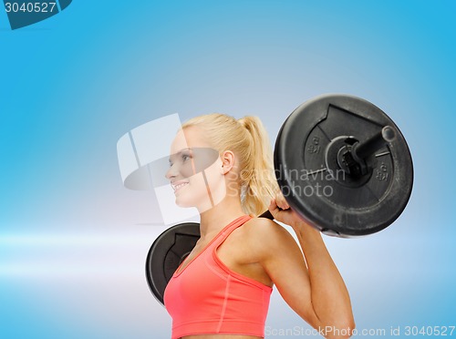 Image of smiling sporty woman exercising with barbell