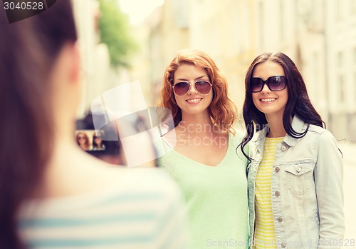 Image of smiling teenage girls with camera