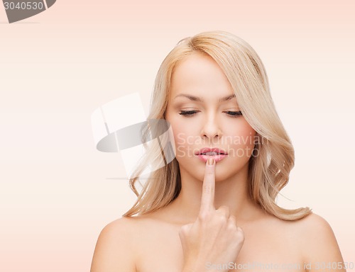 Image of beutiful young woman touching her lips