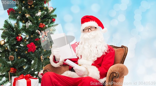 Image of man in costume of santa claus with letter