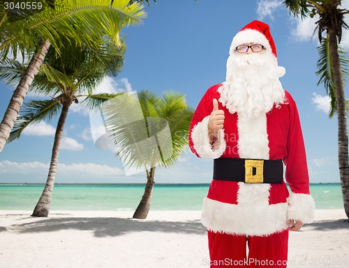 Image of man in costume of santa claus showing thumbs up