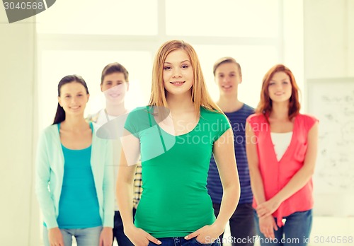 Image of smiling students with teenage girl in front