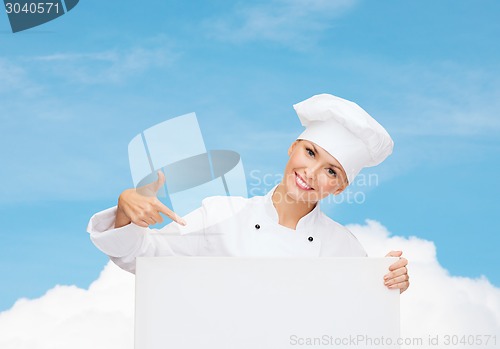 Image of smiling female chef with white blank board