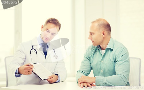 Image of doctor with clipboard and patient in hospital