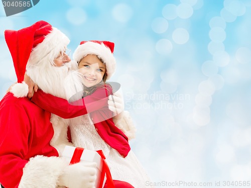 Image of smiling little girl with santa claus