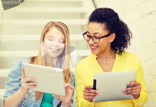Image of smiling female students with tablet pc computer
