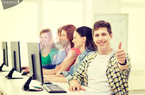 Image of male student with classmates in computer class