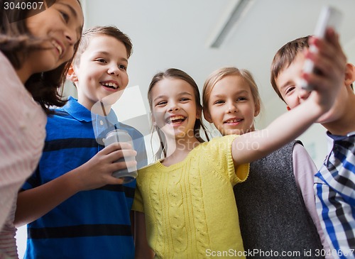 Image of group of school kids with smartphone and soda can