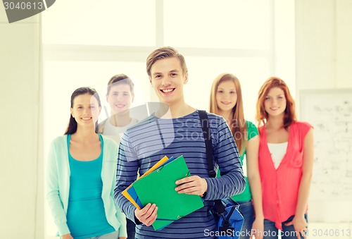 Image of smiling students with teenage boy in front