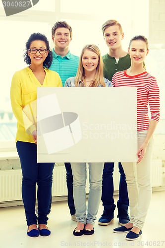Image of smiling students with white blank board at school