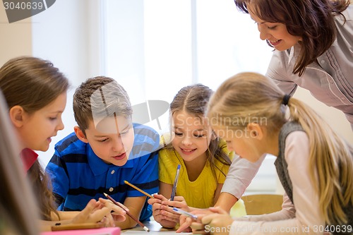 Image of group of school kids writing test in classroom