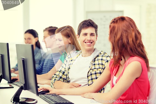 Image of smiling students in computer class at school