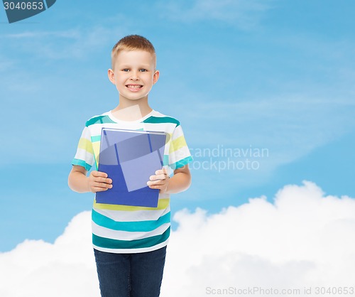 Image of smiling little student boy with blue book