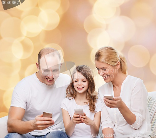 Image of happy family with smartphones