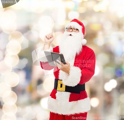 Image of man in costume of santa claus with tablet pc