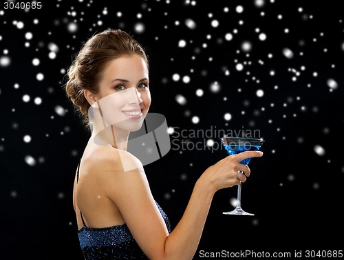 Image of smiling woman holding cocktail