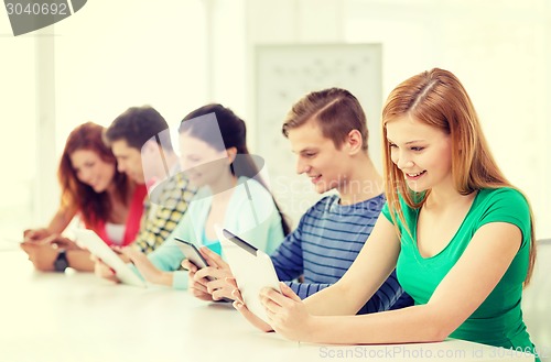 Image of smiling students with tablet pc at school