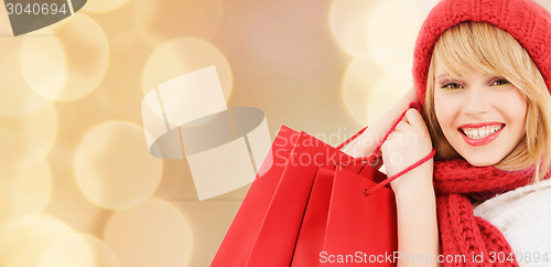 Image of smiling young woman with shopping bags