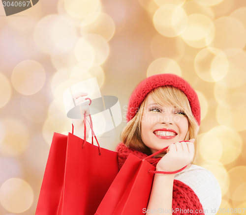 Image of smiling young woman with shopping bags