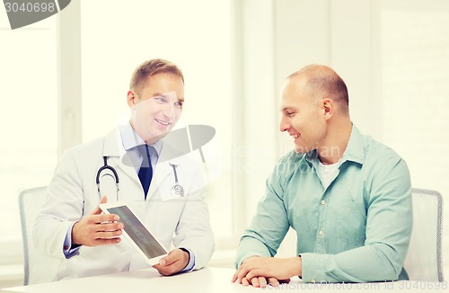 Image of doctor with tablet pc and patient in hospital