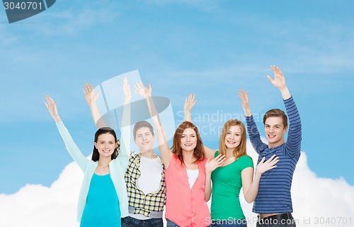 Image of group of smiling students waving hands