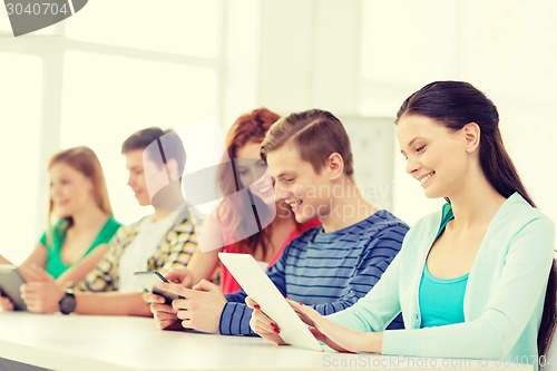 Image of smiling students with tablet pc at school