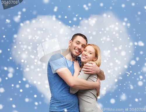 Image of happy couple hugging outdoors