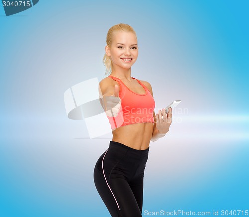 Image of smiling sporty woman with smartphone