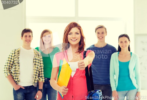 Image of smiling students with teenage girl in front